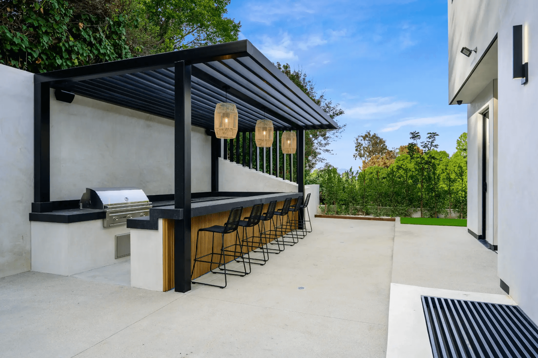 Renovated backyard with travertine pavers and lush desert botanicals
